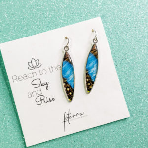 Close up of blue butterfly wing earrings