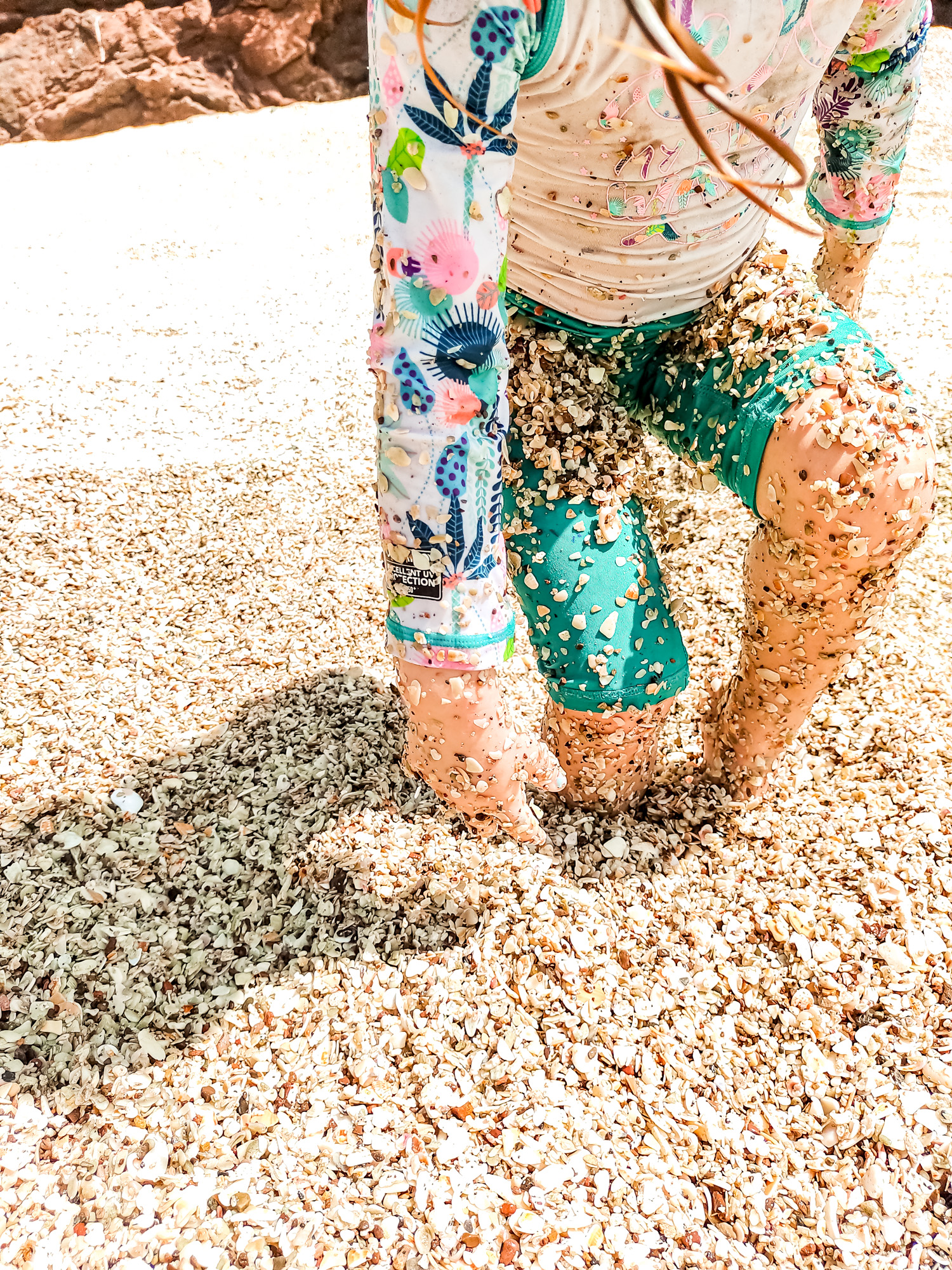 child playing in the shells on Playa Conchal, Costa Rica