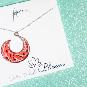 Close up of a pink ginger flower necklace hoop pendant