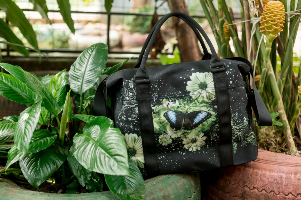 lifestyle image of blue morpho butterfly travel bag