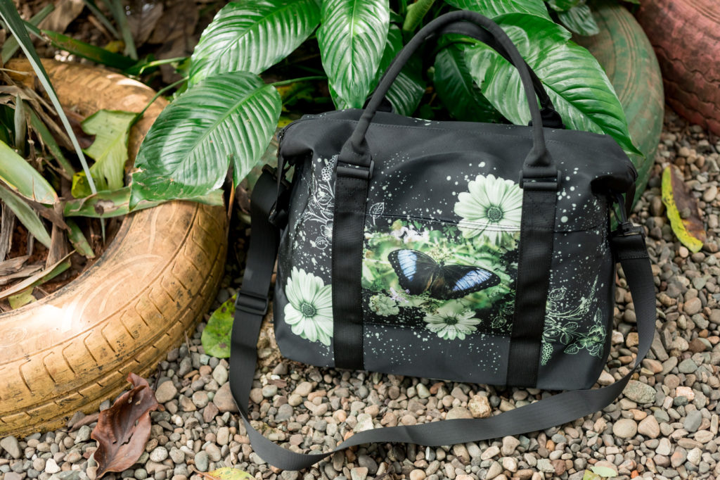 lifestyle image of blue morpho butterfly travel bag