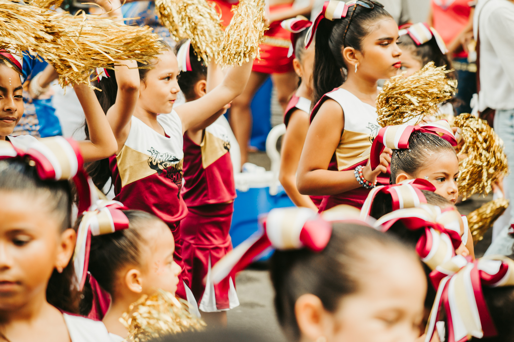 cheerleaders wave pompoms in the parade