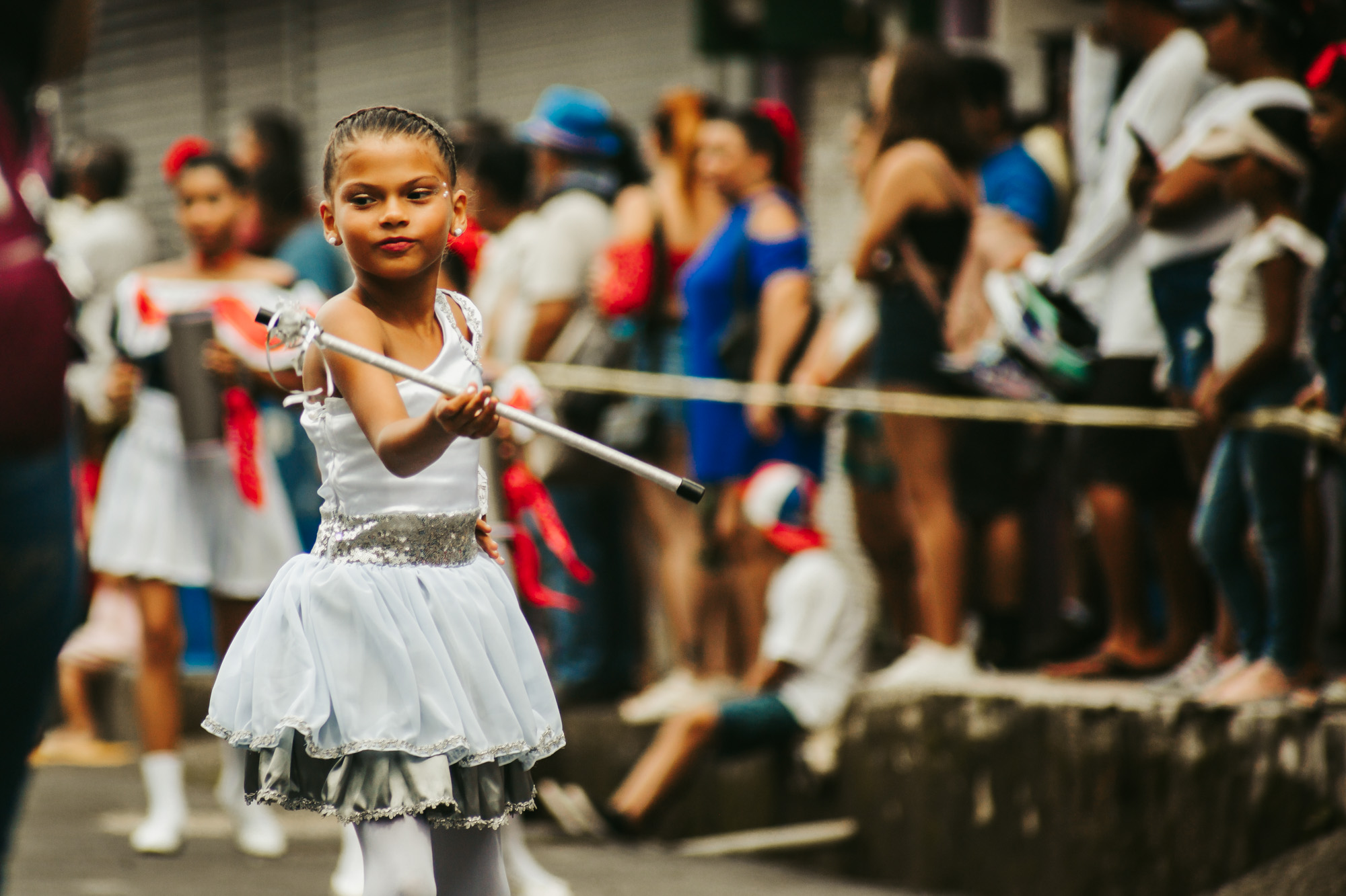 girl twirling baton at independence day parade
