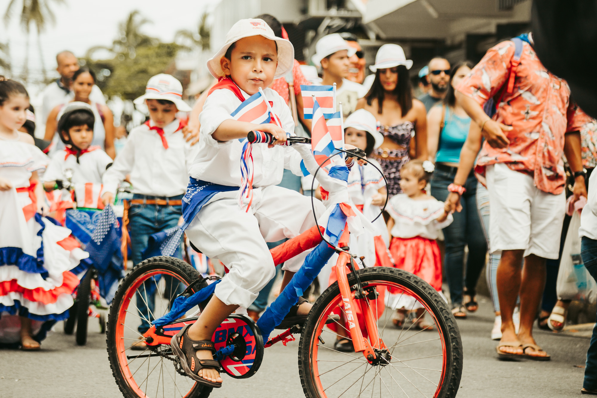 boy rides a bike wearing a traditional costume