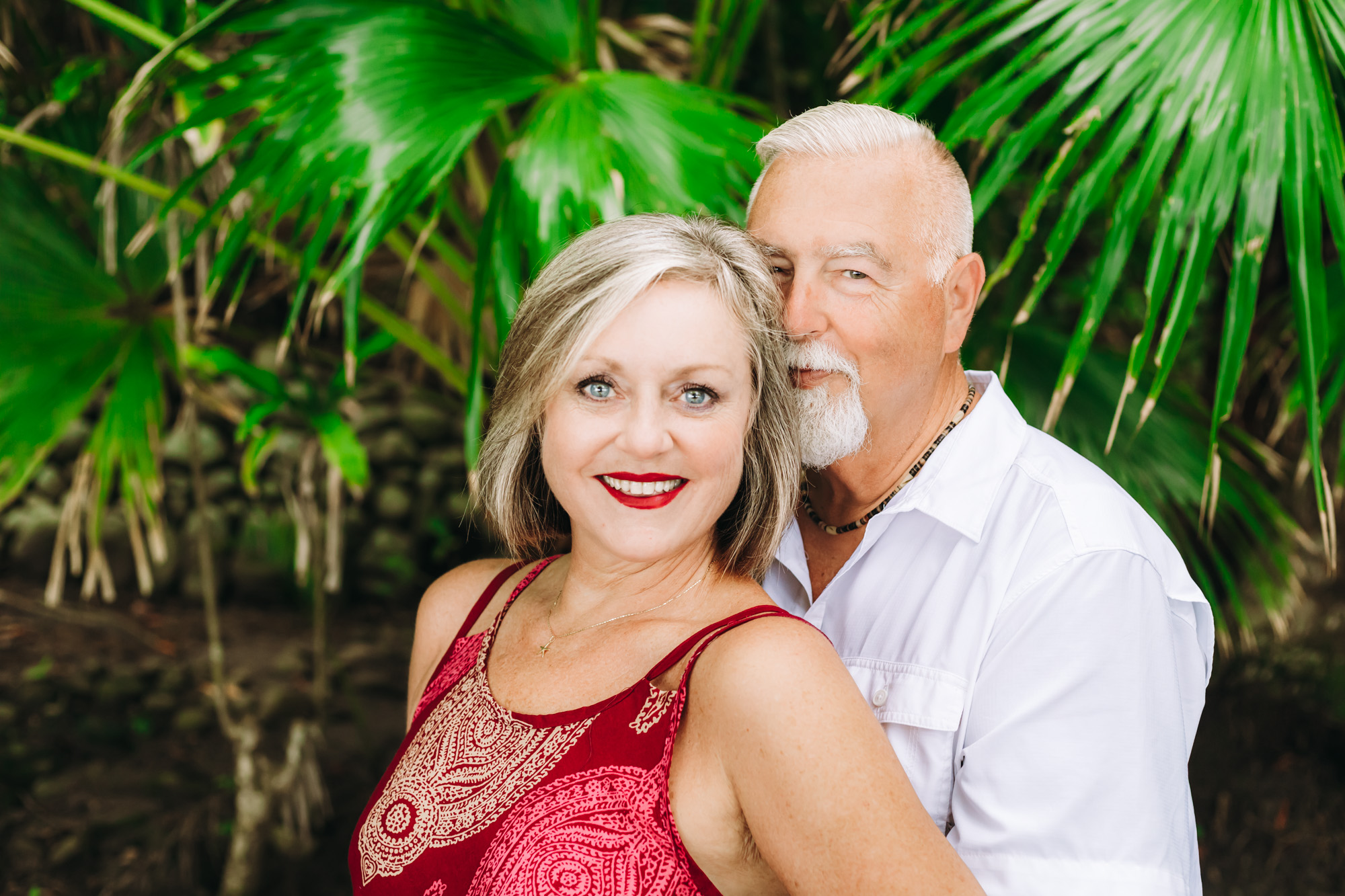 Couple sitting on a log on the beach