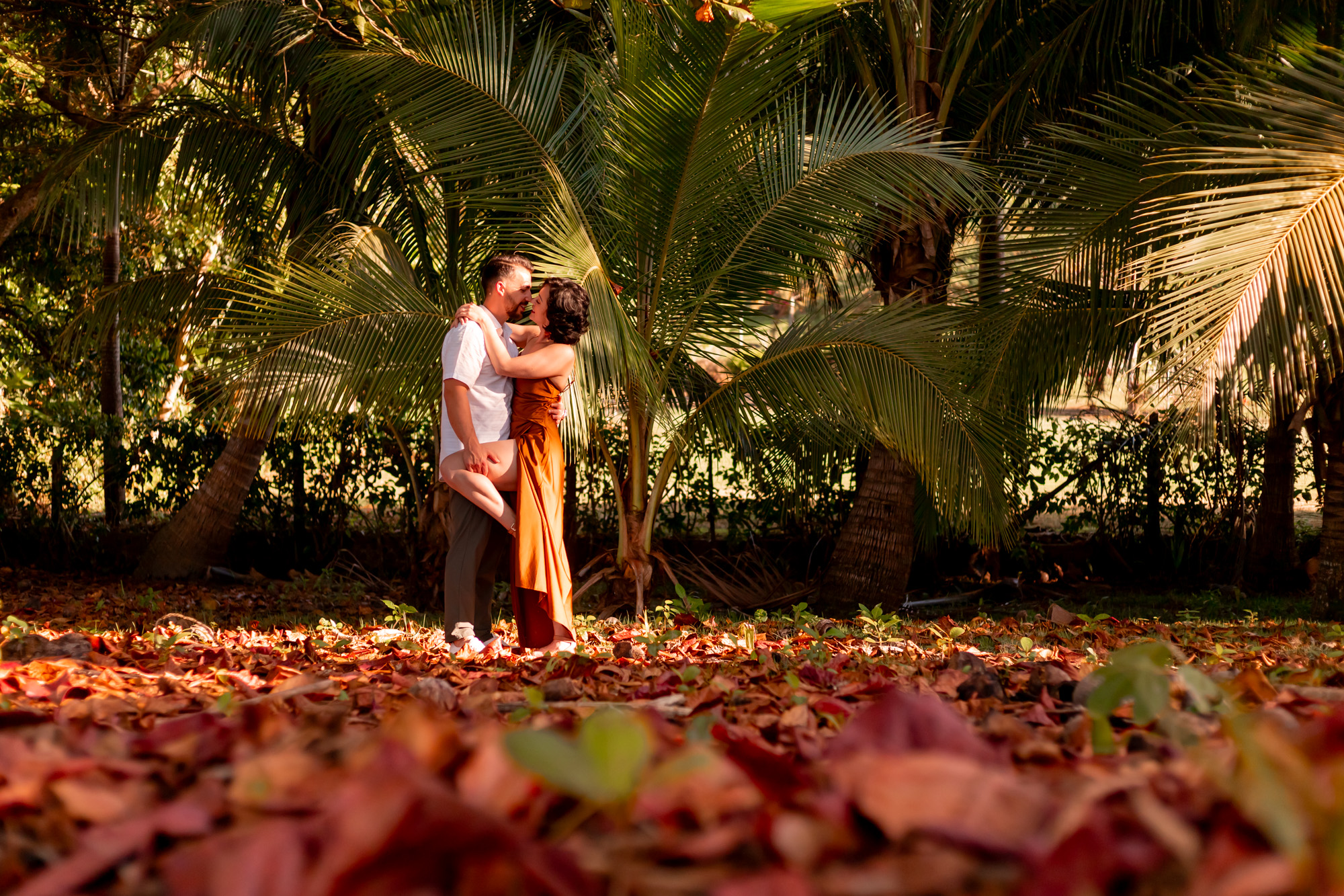 Bride doing the splits across her bridesmaid's laps